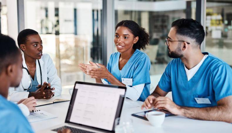 physicians talking to each other at table